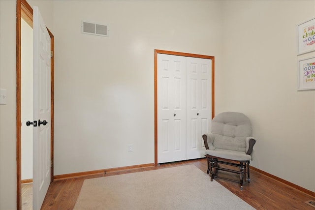 living area with wood finished floors and baseboards
