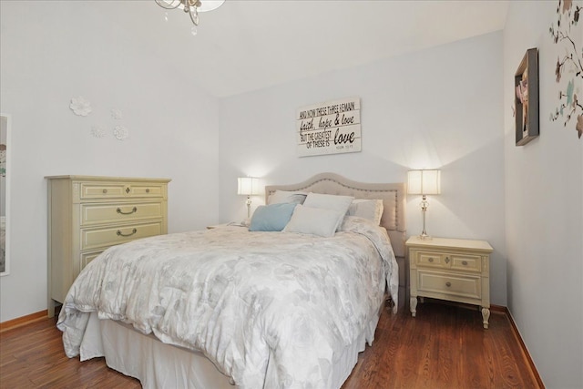bedroom featuring wood finished floors and baseboards