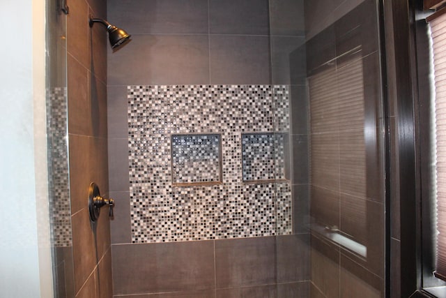 full bathroom with a tile shower