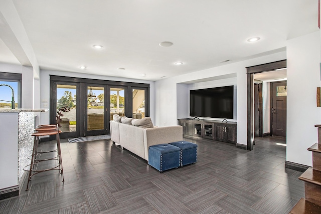 living area featuring recessed lighting, baseboards, and french doors