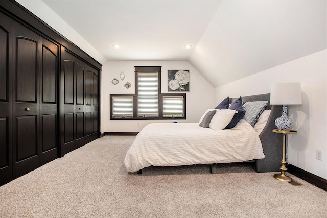 carpeted bedroom featuring baseboards, lofted ceiling, a closet, and recessed lighting