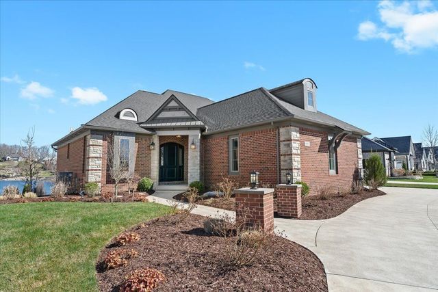 8353 Pier Point Ct, South Lyon, MI 48178 - view of front facade featuring a front lawn, brick siding, and driveway