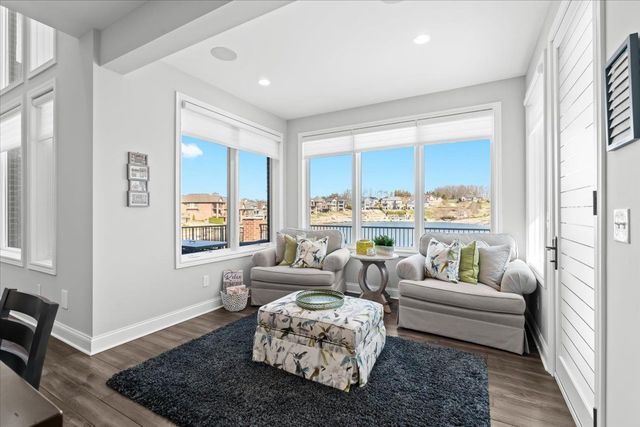 8353 Pier Point Ct, South Lyon, MI 48178 - living room with baseboards, wood finished floors, recessed lighting, and a water view