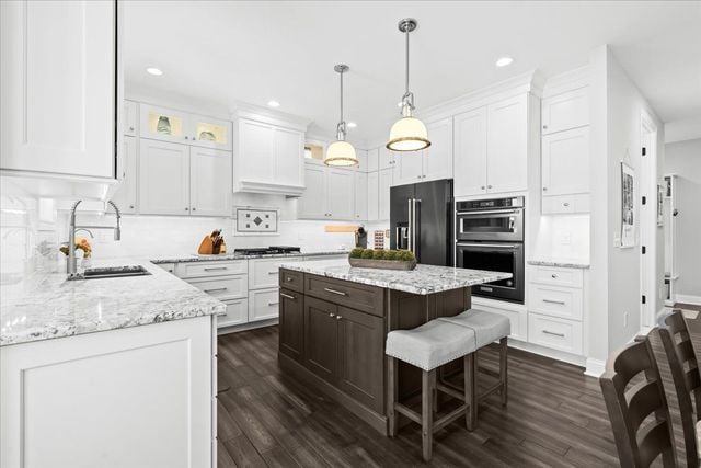 8353 Pier Point Ct, South Lyon, MI 48178 - kitchen with black refrigerator with ice dispenser, a sink, white cabinets, and recessed lighting