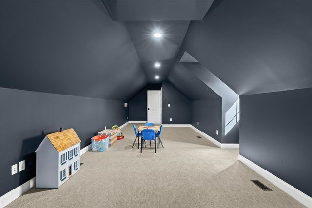 8353 Pier Point Ct, South Lyon, MI 48178 - playroom featuring baseboards, lofted ceiling, carpet, and recessed lighting