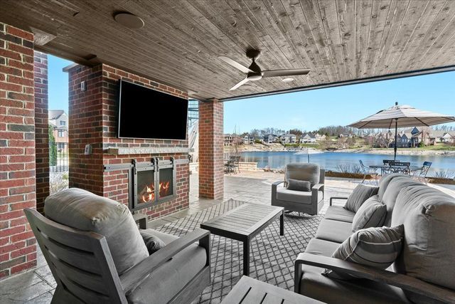 8353 Pier Point Ct, South Lyon, MI 48178 - view of patio with an outdoor living space with a fireplace and a ceiling fan