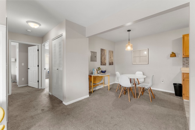 dining space featuring carpet flooring, baseboards, and electric panel