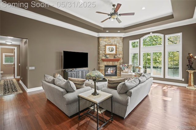 3074 Pond Rd, Leonard, MI 48367 - living room with a tray ceiling, ceiling fan, dark wood-style floors, a fireplace, and recessed lighting