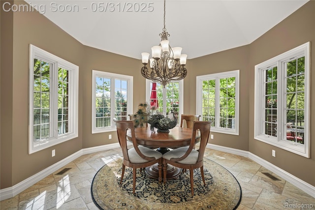 3074 Pond Rd, Leonard, MI 48367 - dining space with stone tile floors, baseboards, healthy amount of natural light, and vaulted ceiling