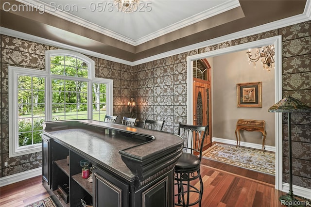3074 Pond Rd, Leonard, MI 48367 - dining area with a chandelier, wood finished floors, baseboards, wallpapered walls, and ornamental molding