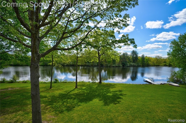 3074 Pond Rd, Leonard, MI 48367 - water view featuring a heavily wooded area and a dock