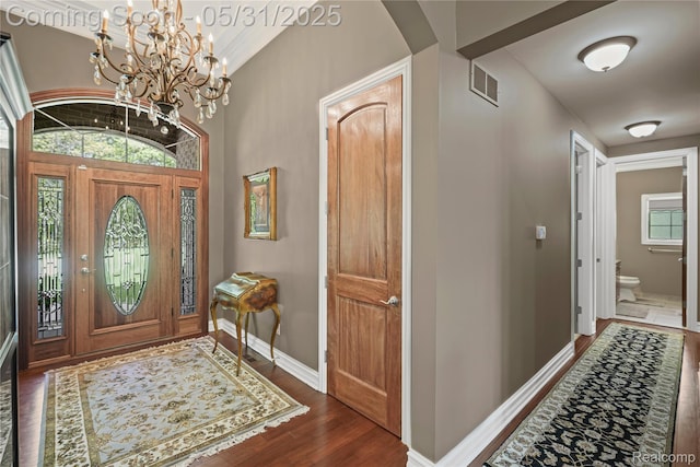 3074 Pond Rd, Leonard, MI 48367 - entryway featuring wood finished floors, a chandelier, baseboards, and arched walkways