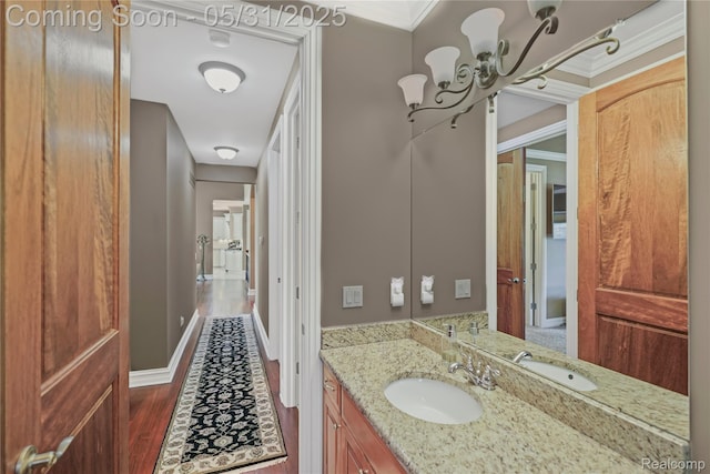 3074 Pond Rd, Leonard, MI 48367 - bathroom featuring a chandelier, vanity, ornamental molding, and wood finished floors