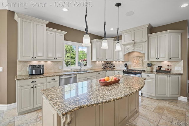 3074 Pond Rd, Leonard, MI 48367 - kitchen featuring stone tile flooring, a sink, stainless steel appliances, a center island, and light stone counters