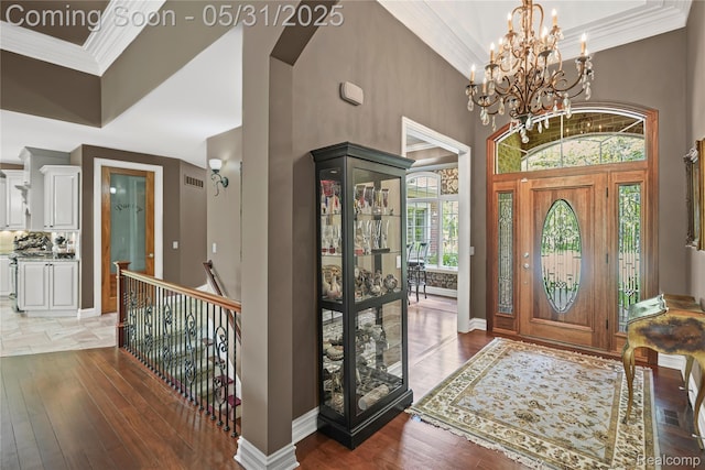 3074 Pond Rd, Leonard, MI 48367 - foyer with hardwood / wood-style flooring, ornamental molding, a chandelier, baseboards, and a high ceiling