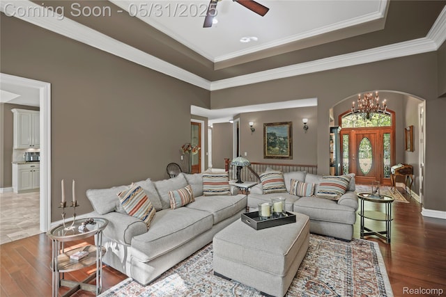 3074 Pond Rd, Leonard, MI 48367 - living room featuring arched walkways, a ceiling fan, wood finished floors, crown molding, and a tray ceiling