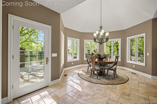 3074 Pond Rd, Leonard, MI 48367 - dining room featuring stone tile floors, a chandelier, baseboards, and high vaulted ceiling