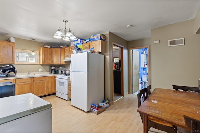 5309 Treat Hwy, Adrian, MI 49221 - kitchen featuring white appliances, under cabinet range hood, a chandelier, light countertops, and light wood-style floors
