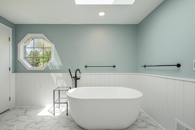 2124 Brockman Blvd, Ann Arbor, MI 48104 - bathroom featuring marble finish flooring, a wainscoted wall, a freestanding tub, and recessed lighting