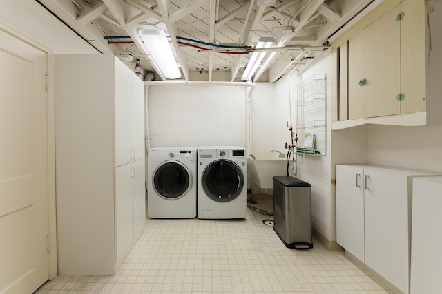 2124 Brockman Blvd, Ann Arbor, MI 48104 - laundry area with washer and clothes dryer, cabinet space, and light floors