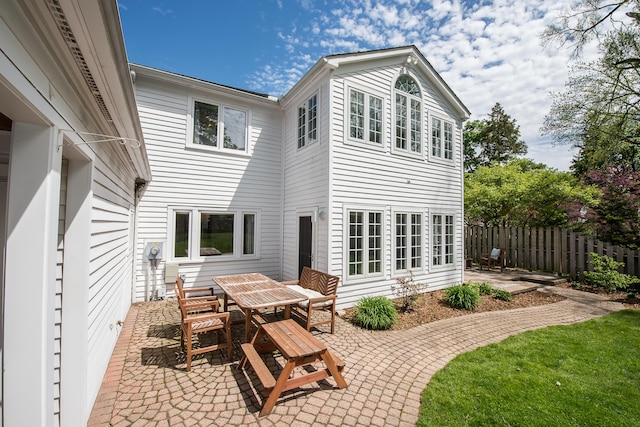 2124 Brockman Blvd, Ann Arbor, MI 48104 - rear view of property featuring a patio area, fence, and outdoor dining space