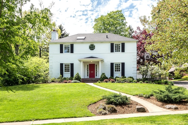 2124 Brockman Blvd, Ann Arbor, MI 48104 - colonial home featuring a chimney, brick siding, and a front yard