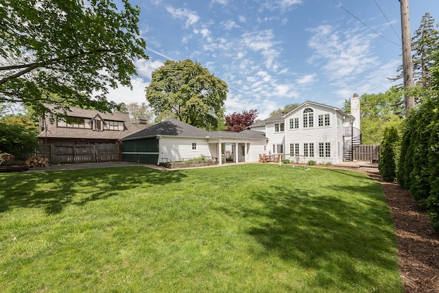 2124 Brockman Blvd, Ann Arbor, MI 48104 - rear view of property featuring a chimney and a sunroom