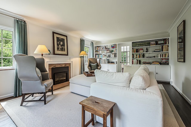 2124 Brockman Blvd, Ann Arbor, MI 48104 - living room featuring a high end fireplace, wood finished floors, plenty of natural light, crown molding, and baseboards