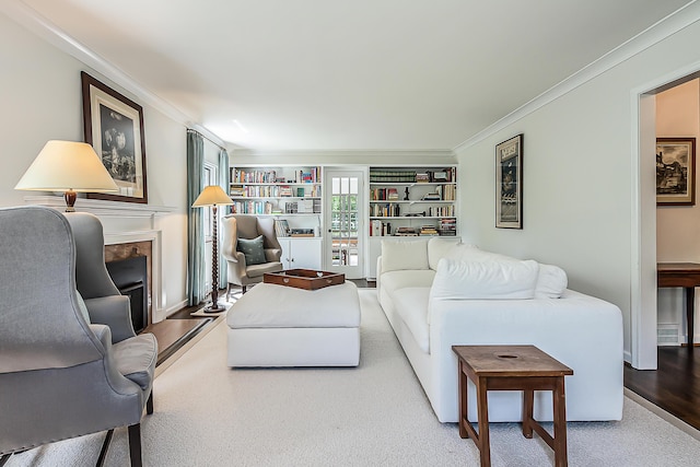 2124 Brockman Blvd, Ann Arbor, MI 48104 - living room with crown molding, a fireplace with flush hearth, wood finished floors, and built in features