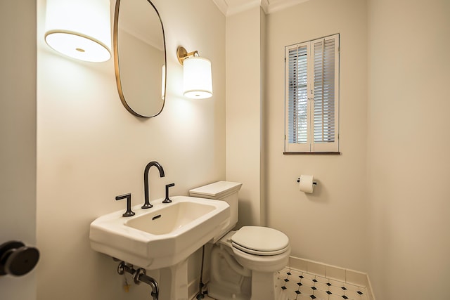 2124 Brockman Blvd, Ann Arbor, MI 48104 - bathroom with toilet, crown molding, baseboards, tile patterned flooring, and a sink