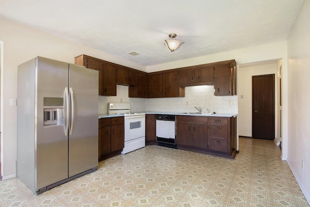 2151 Brown School Rd, Saint Joseph, MI 49085 - kitchen with white appliances, a sink, light countertops, and dark brown cabinets
