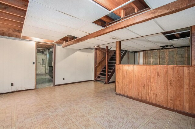 2151 Brown School Rd, Saint Joseph, MI 49085 - finished basement with wooden walls, baseboards, stairway, a drop ceiling, and tile patterned floors