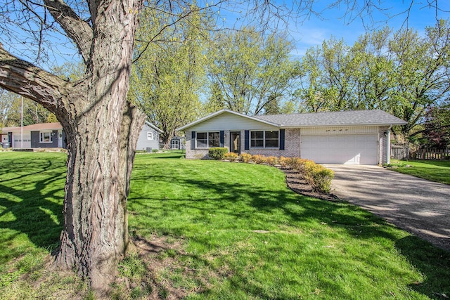 2151 Brown School Rd, Saint Joseph, MI 49085 - view of front of property featuring a garage, brick siding, asphalt driveway, and a front yard