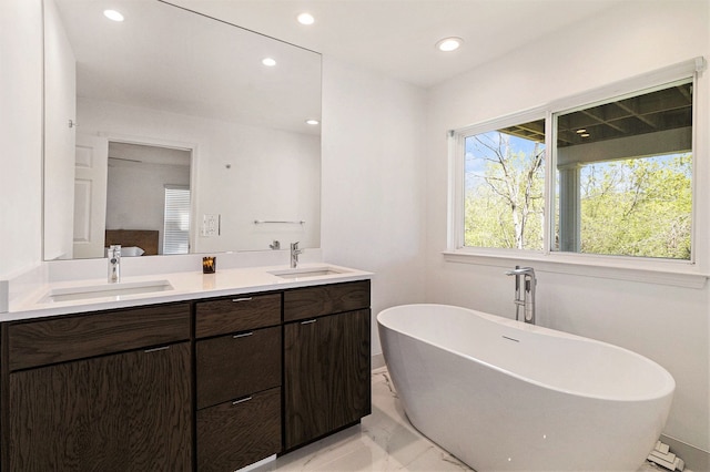 3203 Asher Rd, Ann Arbor, MI 48104 - full bath with marble finish floors, a freestanding tub, recessed lighting, and double vanity