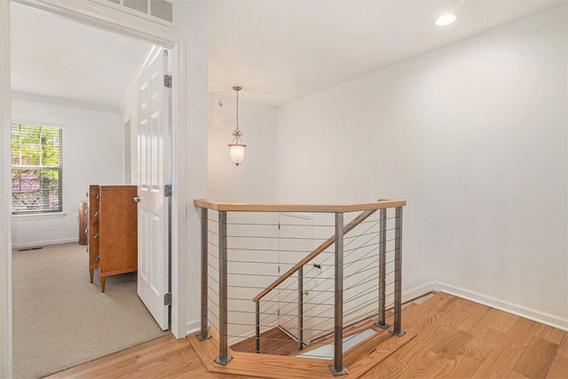 3203 Asher Rd, Ann Arbor, MI 48104 - corridor with an upstairs landing, wood finished floors, and baseboards
