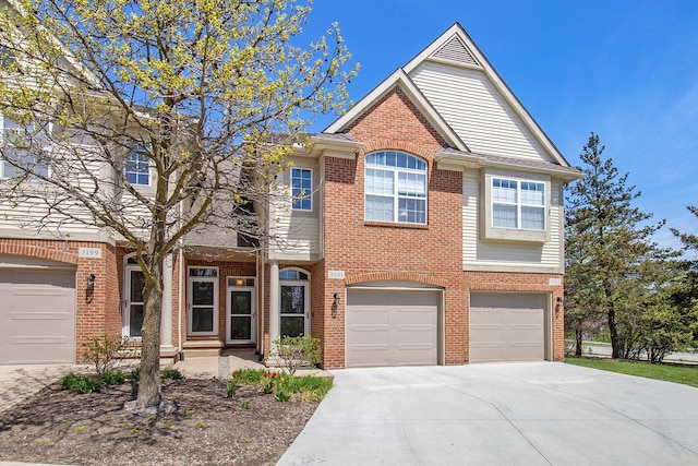 3203 Asher Rd, Ann Arbor, MI 48104 - view of front facade with driveway, brick siding, and an attached garage