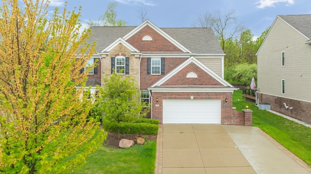 view of front of house with brick siding, a front yard, driveway, and roof with shingles