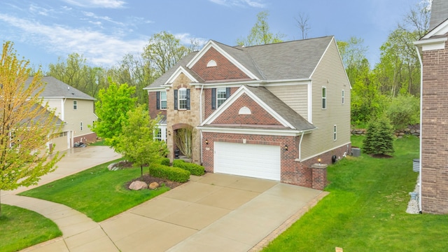 view of front of house featuring a front yard, concrete driveway, brick siding, and roof with shingles