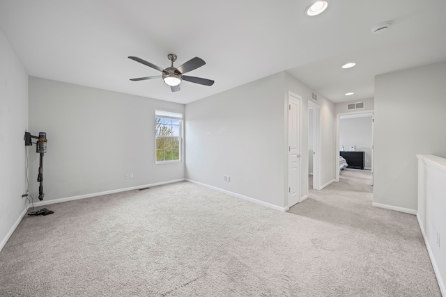 carpeted empty room featuring a ceiling fan, baseboards, recessed lighting, and a smoke detector
