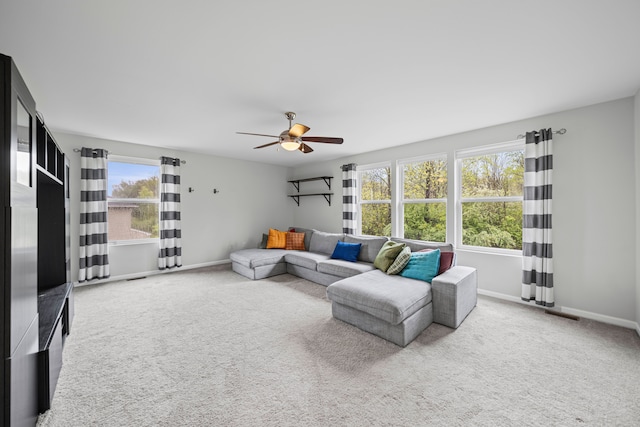 living room with carpet flooring, ceiling fan, and baseboards