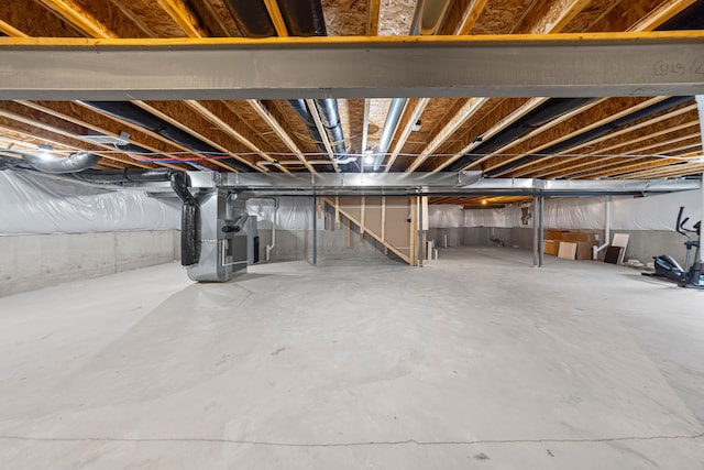 unfinished basement with heating unit and stairway