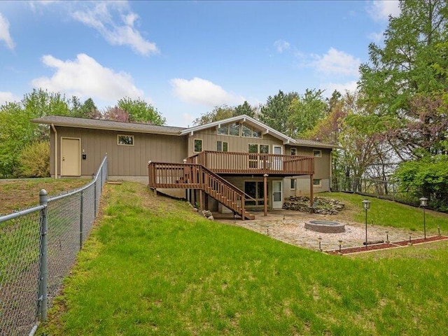 rear view of house with a deck, stairs, and a patio