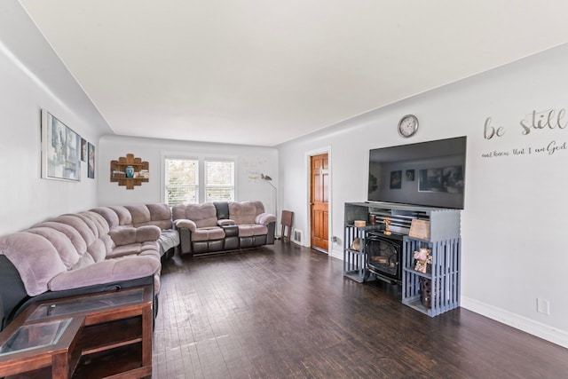 11010 N Holly Rd, Holly, MI 48442 - living area featuring wood finished floors, a wood stove, and baseboards