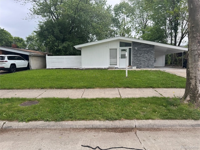 29592 Fairfax St, Southfield, MI 48076 - mid-century inspired home with stone siding, concrete driveway, and an attached carport