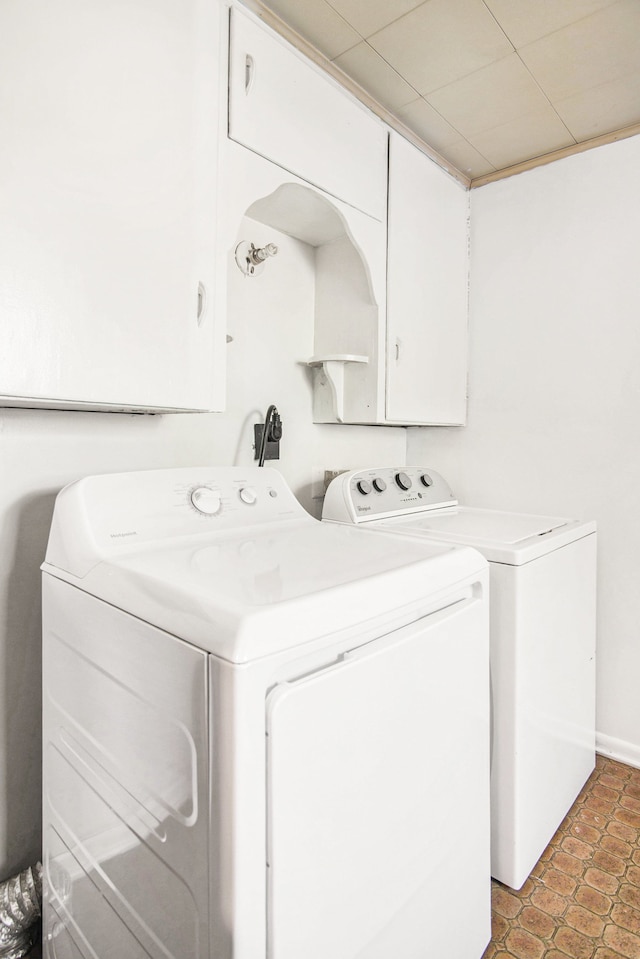 102 Franklin St, Holly, MI 48442 - clothes washing area featuring washing machine and clothes dryer, light tile patterned flooring, and cabinet space