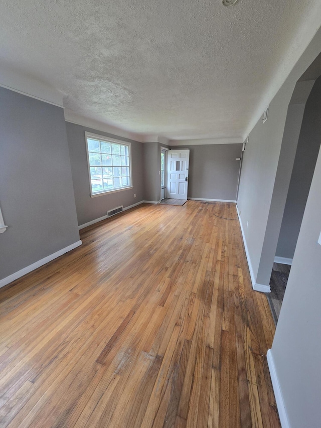 915 Cleophus Pkwy, Lincoln Park, MI 48146 - unfurnished room with a textured ceiling, wood-type flooring, and baseboards