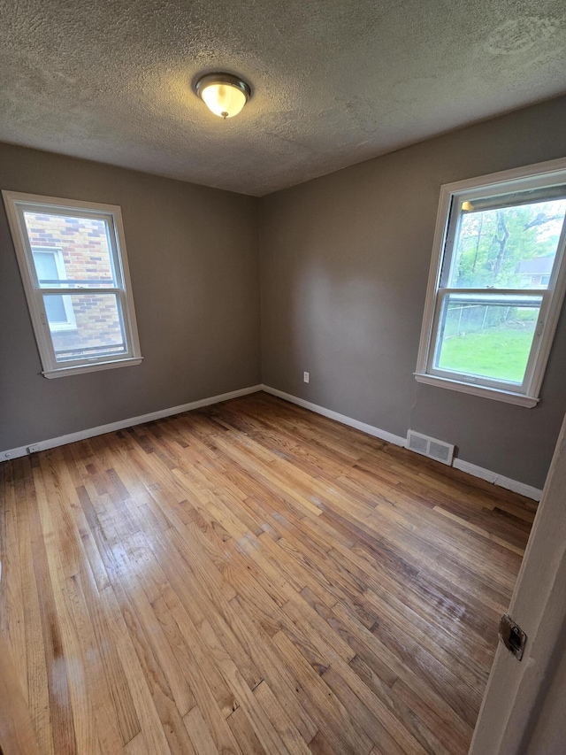 915 Cleophus Pkwy, Lincoln Park, MI 48146 - unfurnished room with wood finished floors, baseboards, and a textured ceiling