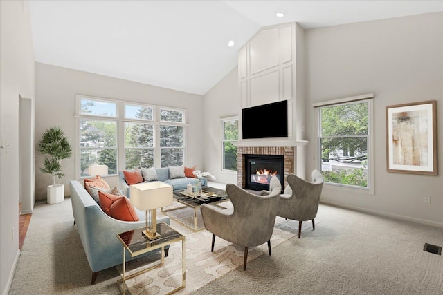 living area featuring high vaulted ceiling, a brick fireplace, baseboards, light carpet, and recessed lighting