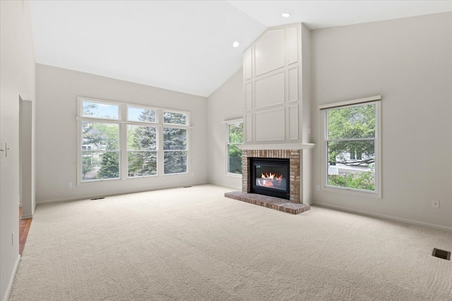 unfurnished living room with high vaulted ceiling, carpet flooring, a fireplace, baseboards, and recessed lighting