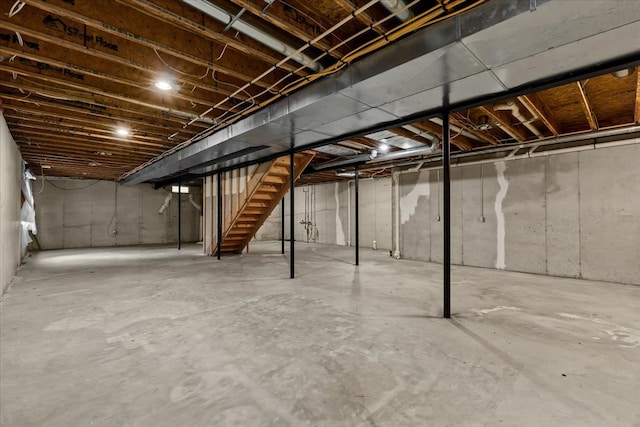 unfinished basement featuring stairs